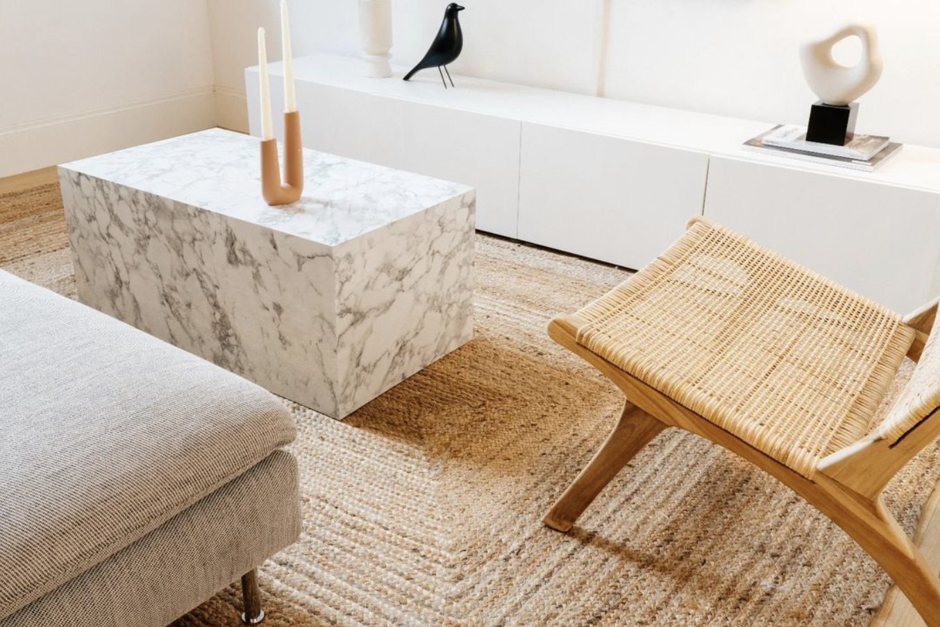 Dezelfde woonkamer na de herstyling: warme materialen, gelaagd licht